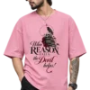 Male fashion model wearing a dusty pink oversized T-shirt featuring a gothic skull, raven, books and the quote “When Reason Fails, the Devil helps!